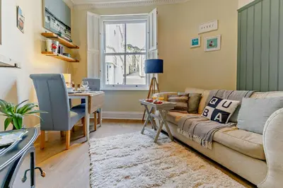 a living room with a couch and a table at 1 Bed in Fowey oc-m27634 in Fowey