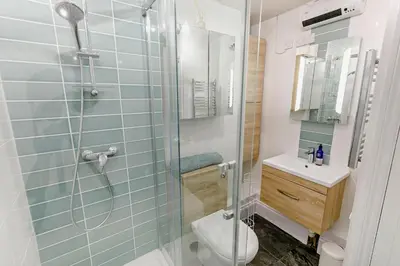 a bathroom with a shower with a toilet and a sink at 1 Bed in Fowey oc-m27634 in Fowey