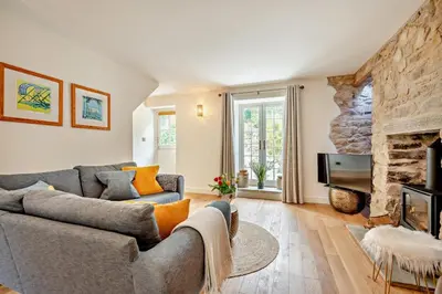 a living room with a couch and a stone fireplace at 3 Bed in Penryn oc-chy969 in Penryn