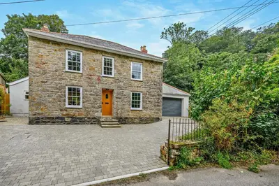 a brick house with a orange door and a driveway at 3 Bed in Penryn oc-chy969 in Penryn