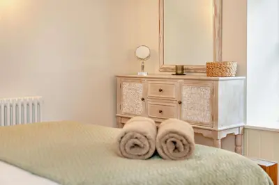 a bedroom with a bed with towels on it at 3 Bed in Penryn oc-chy969 in Penryn