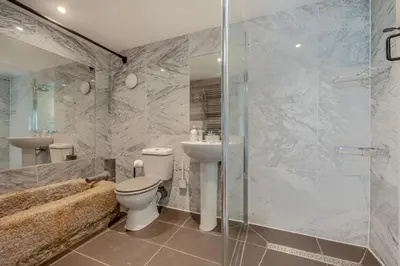 a bathroom with a toilet and a shower and a sink at 5 Bed in Tredethy oc-t31962 in Saint Mabyn