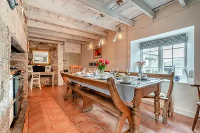 a dining room with a wooden table and chairs at 5 Bed in Tredethy oc-t31962 in Saint Mabyn