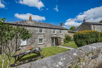 an old stone house with a garden in front of it at 5 Bed in Tredethy oc-t31962 in Saint Mabyn