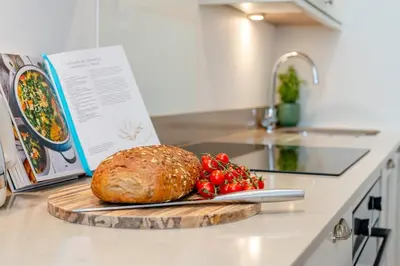 a loaf of bread on a cutting board on a kitchen counter at 2 Bed in Padstow oc-f32031 in Padstow