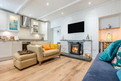a living room with a couch and a fireplace at 2 Bed in Padstow oc-f32031 in Padstow