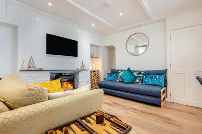 a living room with a couch and a fireplace at 2 Bed in Padstow oc-f32031 in Padstow