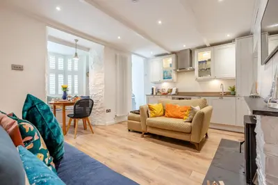 a living room with a couch and a kitchen at 2 Bed in Padstow oc-f32031 in Padstow