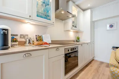 a kitchen with white cabinets and a counter top at 2 Bed in Padstow oc-f32031 in Padstow