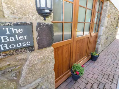 a building with a sign that reads the baker house at The Baler House in Hayle
