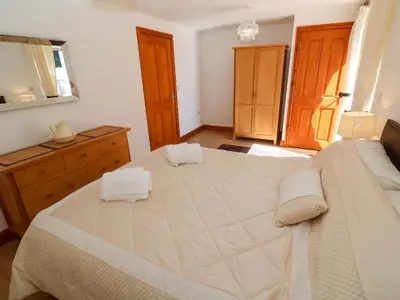 a bedroom with a large bed with two towels on it at The Stable Barn in Hayle