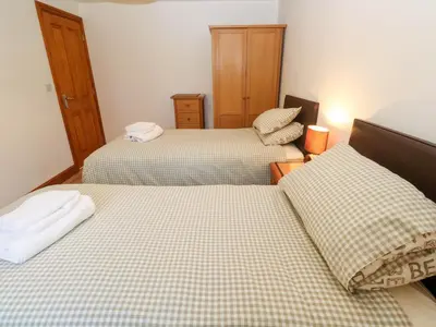 two beds in a small room with two beds sidx sidx sidx at The Stable Barn in Hayle