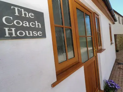 a sign on the door of a coach house at The Coach House in Hayle