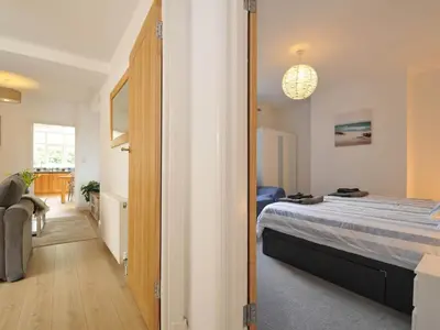 a bedroom with a bed and a hallway at Falmouth Bay 1 in Falmouth