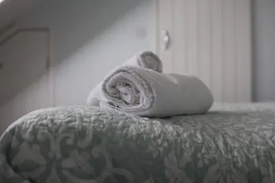 a pile of towels sitting on top of a bed at 4 St Eia - Happy Place in St Ives