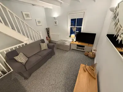 a living room with a couch and a television at 4 St Eia - Happy Place in St Ives