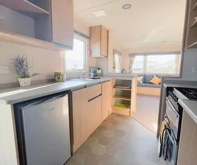 a kitchen with a sink and a dishwasher at Dune Breeze-Haven Perran Sands Holiday Park in Perranporth