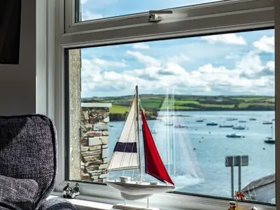 a window with a sail boat in the water at 6 Slipway in Padstow