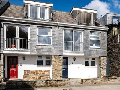 a house with a red door and windows at 6 Slipway in Padstow