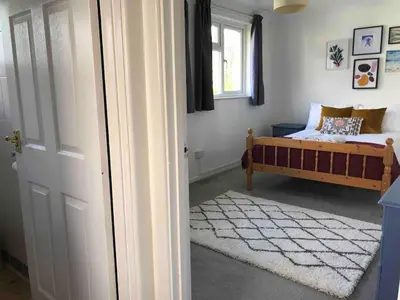 a bedroom with a bed and a window at Stylish Room Close to Beaches in Falmouth