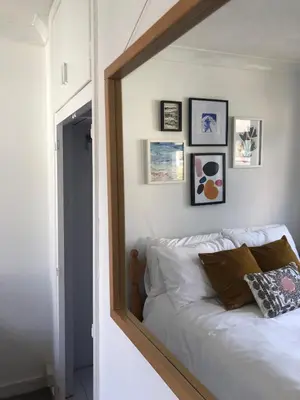 a mirror reflection of a bed in a bedroom at Stylish Room Close to Beaches in Falmouth