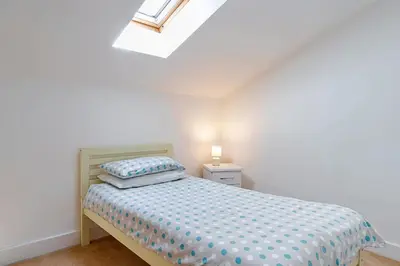 a small bedroom with a bed and a window at Finest Retreats - Stable Barn Apartment at Bodmin Moor in Saint Breward