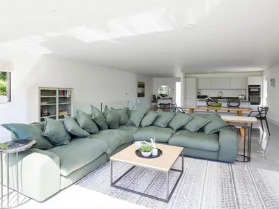 a living room with a blue couch and a table at 1 Zeath in Polzeath