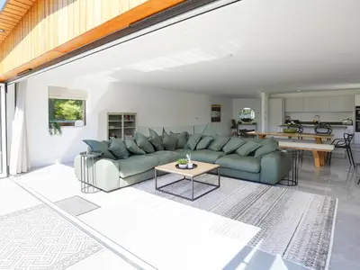 a living room with a couch and a table at 1 Zeath in Polzeath