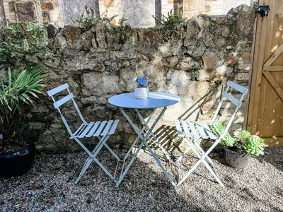 two chairs and a table with a blue table and chairs at Palm Haven House - Luxury family-friendly Newquay surf house near Porth Beach perfect for walking, pets, exploring in Newquay