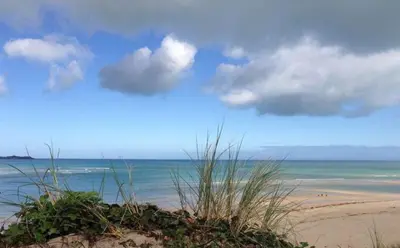 a sandy beach with a view of the ocean at Sunset Sea Views 1 min to beach On SW Coast Path Private Parking in Uny Lelant