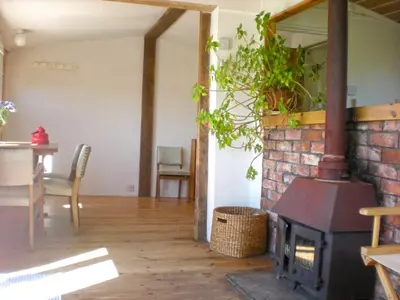 a living room with a brick fireplace and a table at Sunset Sea Views 1 min to beach On SW Coast Path Private Parking in Uny Lelant
