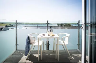 a white table and chairs on a balcony at 17 Slipway in Padstow