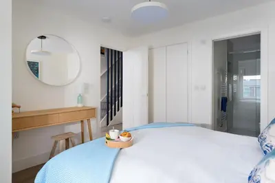a bedroom with a bed with a bowl of fruit on it at 17 Slipway in Padstow