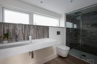 a bathroom with a sink and a toilet and a shower at 17 Slipway in Padstow