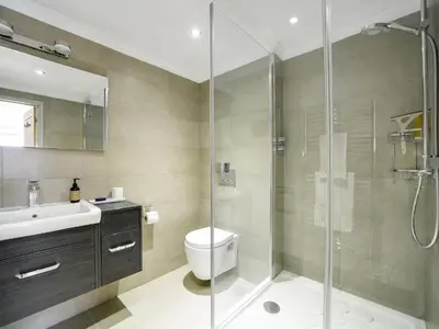 a bathroom with a shower and a toilet and a sink at 11 Slipway in Padstow