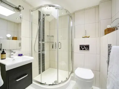 a bathroom with a shower and a toilet and a sink at 11 Slipway in Padstow