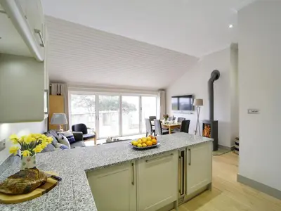 a kitchen with a counter with a bowl of fruit on it at 11 Slipway in Padstow