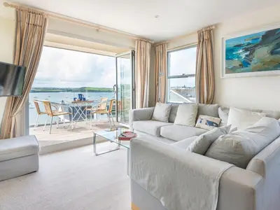 a living room with a couch and a large window at 23 Slipway in Padstow