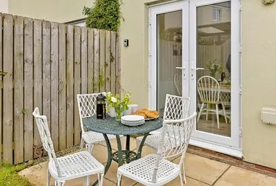 a table and chairs on a patio at Finest Retreats - Cove House in St Austell