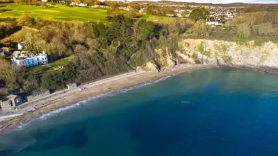 an aerial view of a beach and the ocean at Finest Retreats - Cove House in St Austell