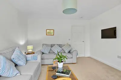 a living room with a couch and a table at Finest Retreats - Cove House in St Austell