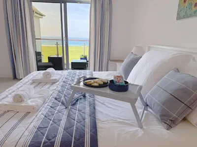 a bedroom with a bed with a tray of food on it at Penthouse at Bredon in Newquay