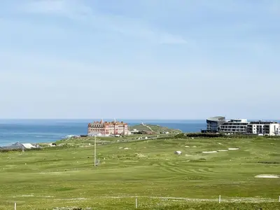a golf course with the ocean in the background at Penthouse at Bredon in Newquay