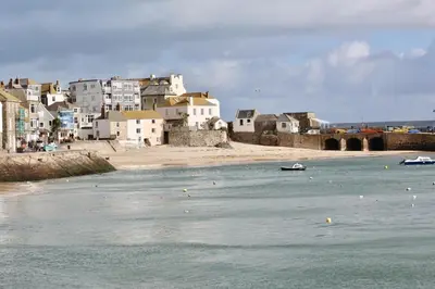 a view of a beach with houses and a city at Old Temperance House in Saint Keverne