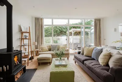 a living room with a couch and a fireplace at 4 The Sands in Polzeath
