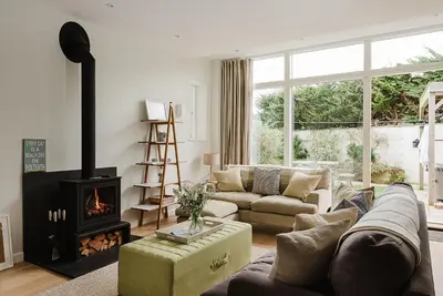 a living room with a couch and a fireplace at 4 The Sands in Polzeath