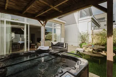 a hot tub in the backyard of a house at 4 The Sands in Polzeath