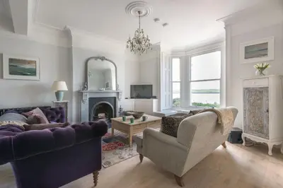 a living room with two couches and a fireplace at 5 The Terrace in Padstow