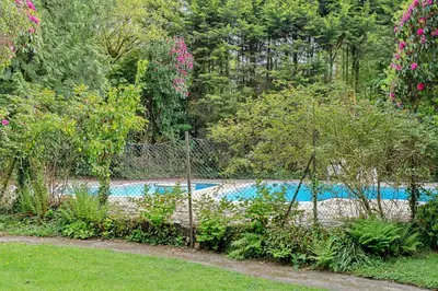 a fence in front of a swimming pool at Finest Retreats - Lanteglos Villa in Camelford