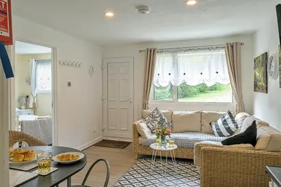 a living room with a couch and a table at Finest Retreats - Lanteglos Villa in Camelford